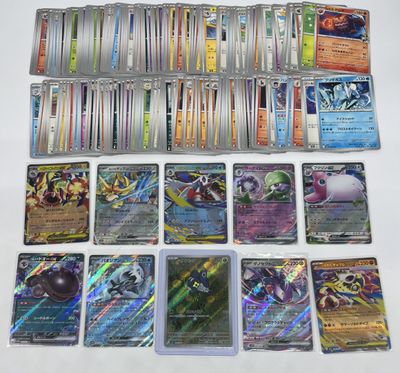 a lot of different pokemon cards on the table