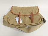 tan canvas messenger bag with tan leather handles and brown leather straps