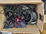 a cardboard box filled with headphones and other electronics