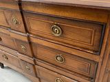 an image of a wooden dresser with brass knobs