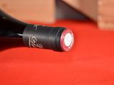 a bottle of wine sitting on a red table