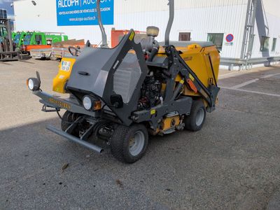 a yellow machine that is parked in a parking lot
