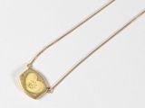gold plated necklace with a heart shaped pendant and a chain