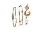an assortment of gold jewellery including a necklace, bracelet, and broochet