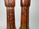 two vases that have been painted with trees on them