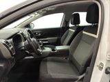 the interior of a car with the door open and the driver ' s seat down
