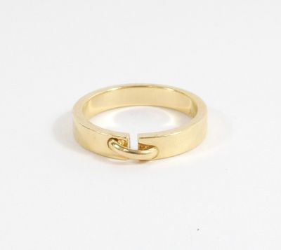 a close up of a gold ring on a white surface