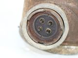 a close up view of a rusted metal object on a white surface