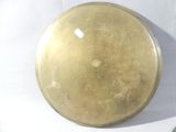 a picture of a brass plate on a white table