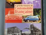 two books on a table with a car and a truck in front of them