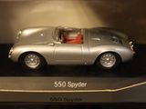 a silver toy car with a red top in a display case
