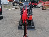 a red tractor that is parked in a lot