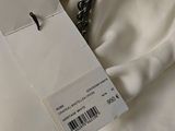 an image of a white shirt with a tag attached to it