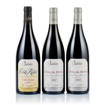three bottles of wine are lined up on a white surface