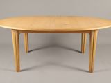 une table en bois à deux pieds avec un plateau rond