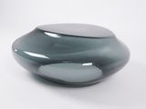 a glass vase that is sitting on a white surface