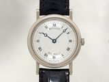 a silver wrist watch with roman numerals on the face