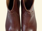 pair of brown leather boots on a white background