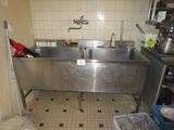 a large stainless steel sink in the middle of a kitchen