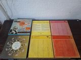 five books on a table that are sitting on top of each other