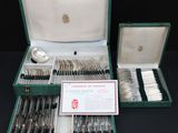 a green case with silverware in it on a table
