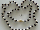 black and white pearl necklace with a gold clasp