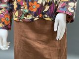 an image of a mannequin wearing a colorful jacket and skirt