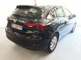 the back end of a black car parked in a white room