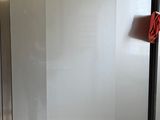 a silver refrigerator with a blue sign on the door