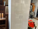 a large white cabinet in the middle of a room
