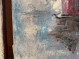 a picture of a painting on a easel with a cat sitting next to it