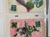 two cards with fish and flowers on them on a table