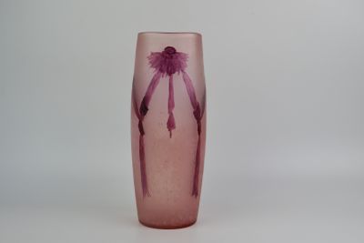 a pink glass vase with a purple flower on it