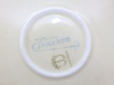 a close up of a white plate with a blue writing on it
