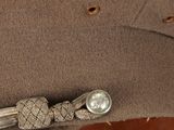 a close up of a hat on a chair with a button