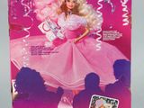 the barbie doll is in a pink dress and is ready to be played
