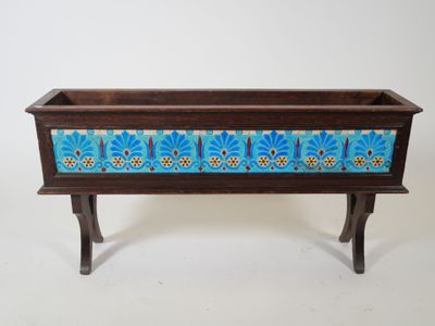 an old wooden planter with a blue and yellow design on it