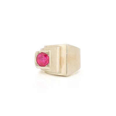 a close up of a ring with a ruby stone in it