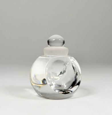 a clear glass jar with a white lid on a table