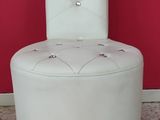 a white chair that is sitting in front of a red wall