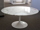 a marble table with a white base in a living room