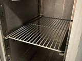 an open oven with a rack in the middle of it