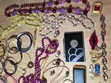 a lot of jewelry that is laying out on the table