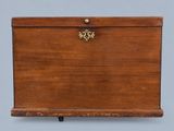 an old wooden box with a key on top of it