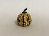 yellow and black polka dot pumpkin on white background