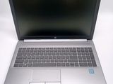 an open laptop computer sitting on top of a white table