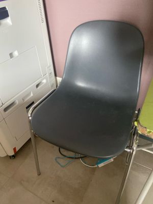 a chair that is sitting next to a washing machine