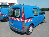 two blue vans parked in a parking lot next to each other