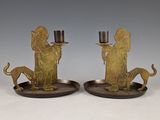 pair of brass figurines of a man and a woman with a dog