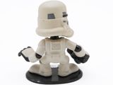 a toy figure of a stormtrooper holding a gun